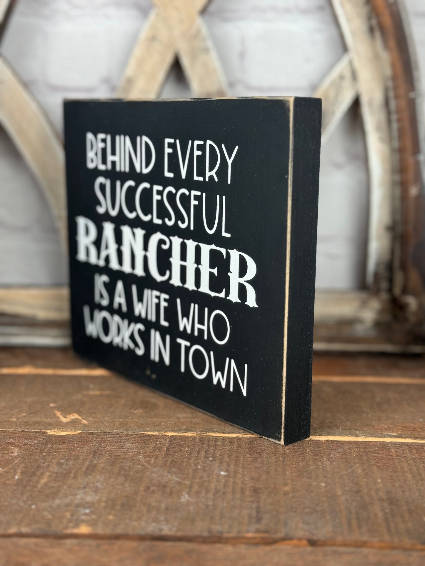 BEHIND EVERY SUCCESSFUL FARMER/RANCHER IS A WIFE WHO WORKS IN TOWN- WOOD SIGN